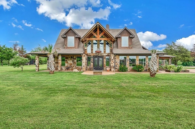 back of property featuring a lawn and french doors