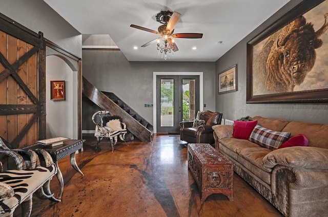 living room featuring french doors, a barn door, and ceiling fan