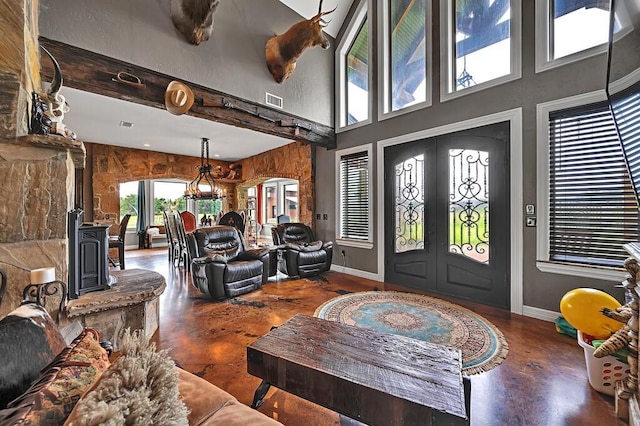 entryway with beam ceiling, french doors, and a towering ceiling