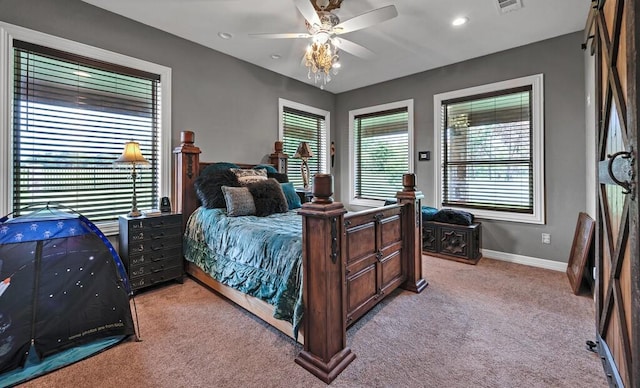 bedroom with ceiling fan and light carpet