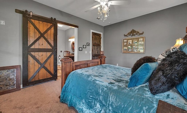 carpeted bedroom featuring ceiling fan and a barn door