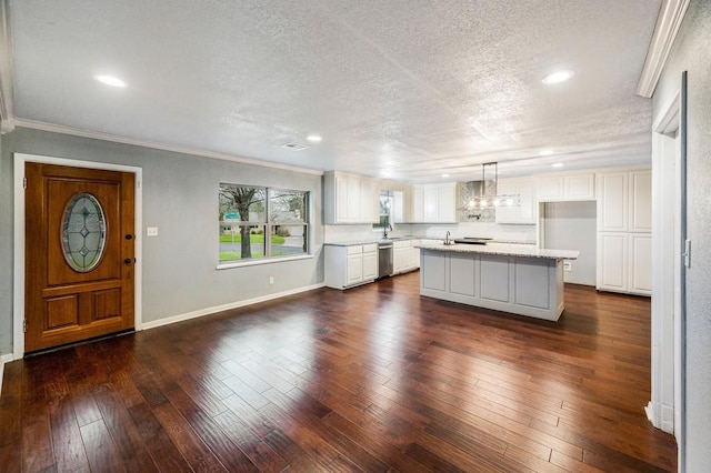 kitchen featuring a kitchen island, white cabinetry, hanging light fixtures, and dark wood-type flooring