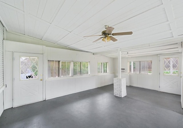 unfurnished sunroom featuring ceiling fan, a healthy amount of sunlight, and lofted ceiling