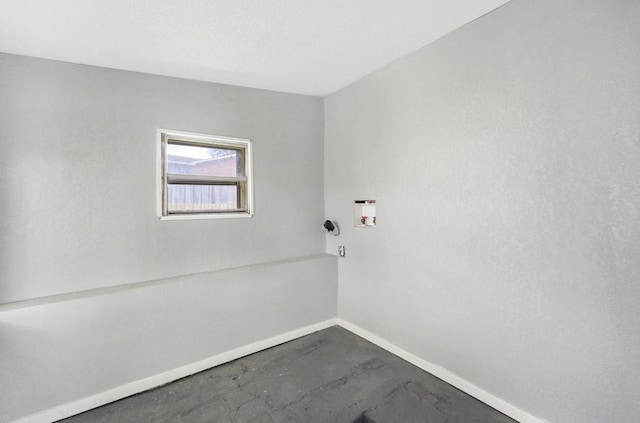 unfurnished room featuring concrete floors