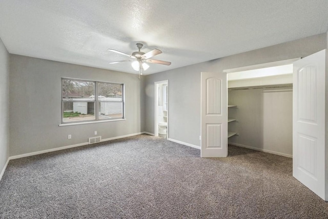 unfurnished bedroom with carpet flooring, a textured ceiling, a closet, and ceiling fan