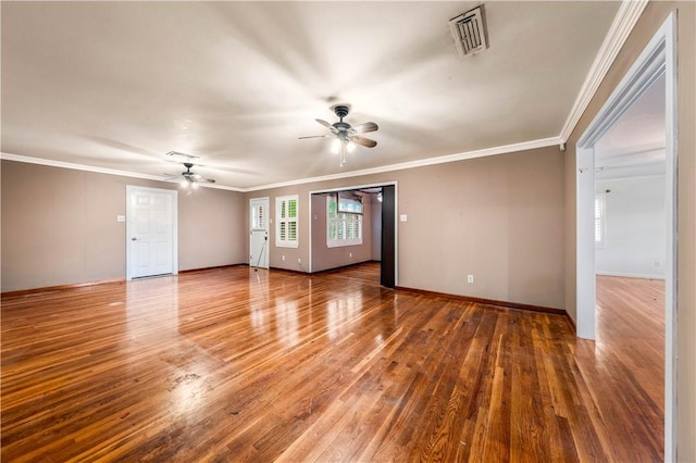 empty room featuring hardwood / wood-style floors, crown molding, and ceiling fan