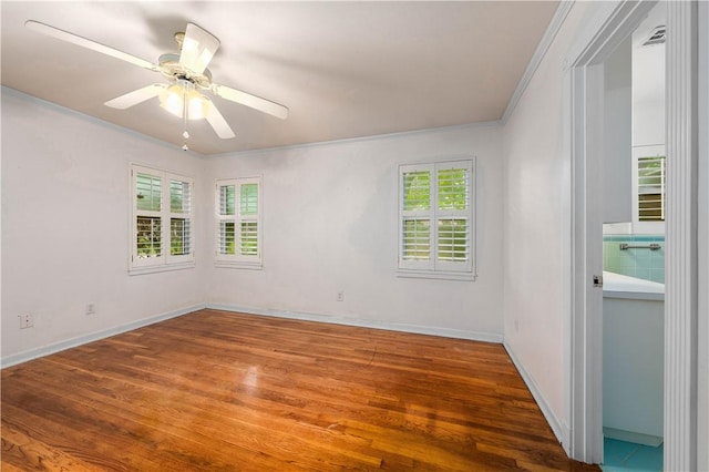 empty room featuring wood-type flooring, ornamental molding, and ceiling fan