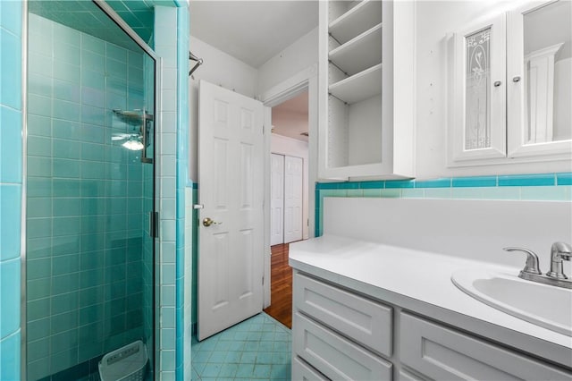 bathroom featuring vanity and a shower with door