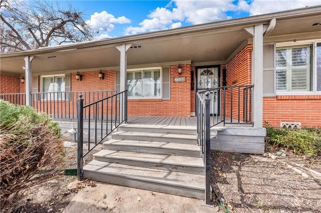 view of exterior entry with a porch