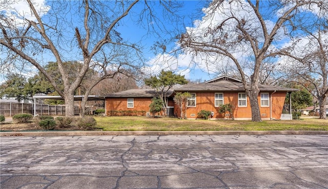 single story home featuring a carport and a front lawn