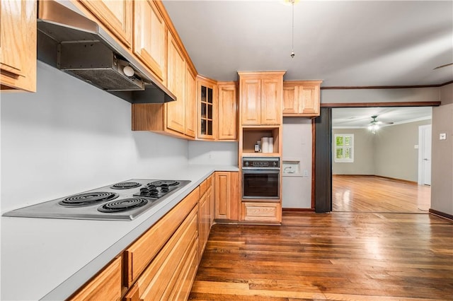 kitchen with black oven, electric stovetop, dark hardwood / wood-style flooring, ornamental molding, and ceiling fan