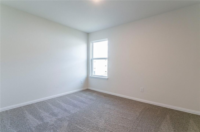 spare room with carpet floors and baseboards