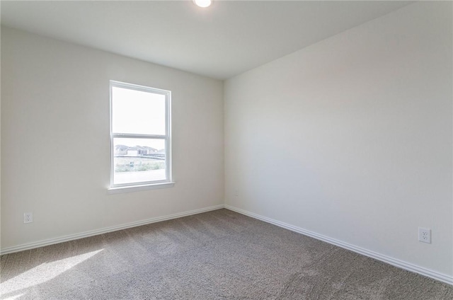 spare room with carpet floors and baseboards