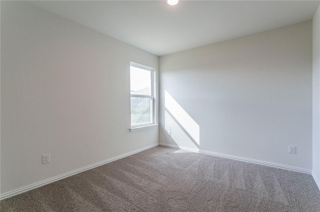 empty room with carpet flooring and baseboards