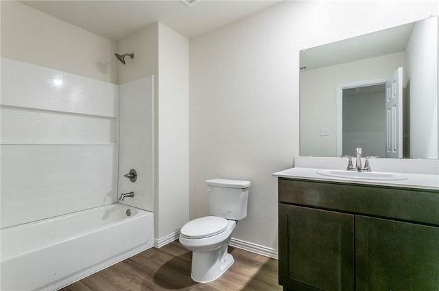 full bathroom featuring shower / bathing tub combination, toilet, vanity, wood finished floors, and baseboards