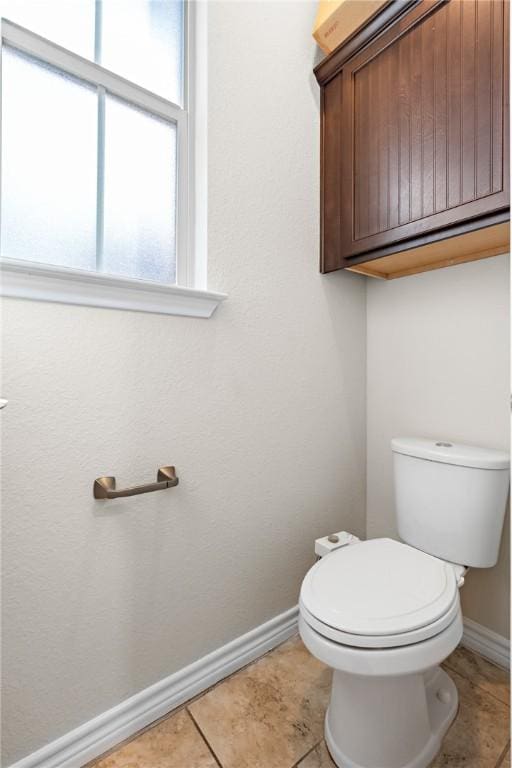 bathroom with tile patterned flooring and toilet