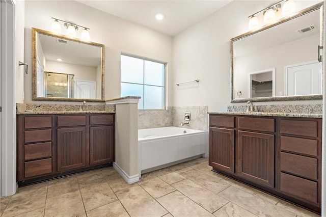 bathroom featuring vanity and separate shower and tub