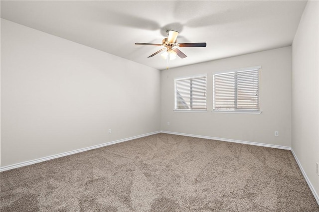 unfurnished room featuring ceiling fan and carpet