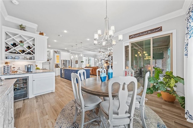 dining space featuring light hardwood / wood-style flooring, beverage cooler, and crown molding