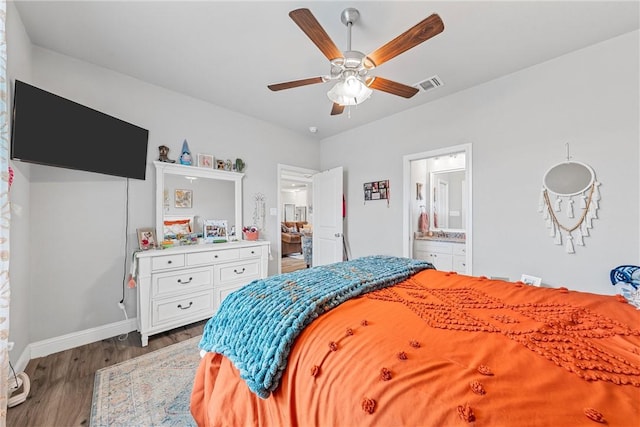 bedroom featuring ensuite bath, ceiling fan, and dark hardwood / wood-style flooring