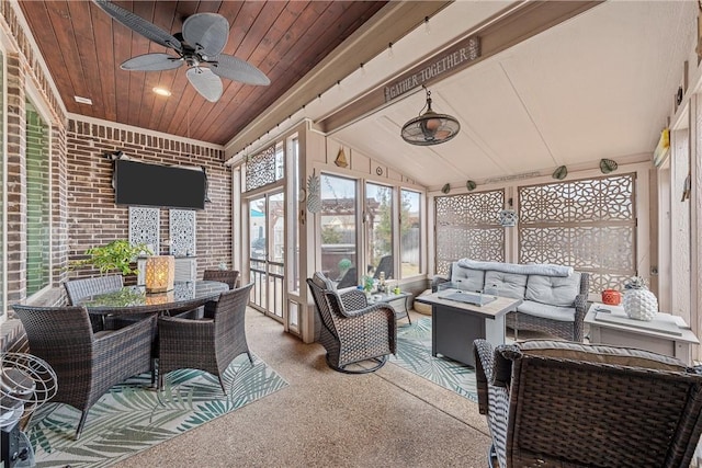 sunroom featuring ceiling fan, wooden ceiling, and lofted ceiling