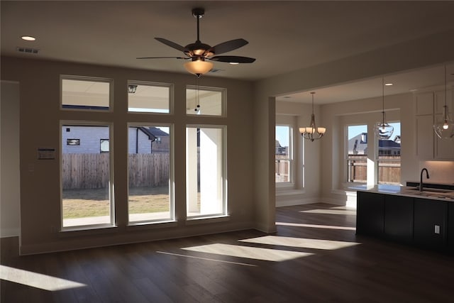 entryway with ceiling fan with notable chandelier, a healthy amount of sunlight, dark hardwood / wood-style flooring, and sink