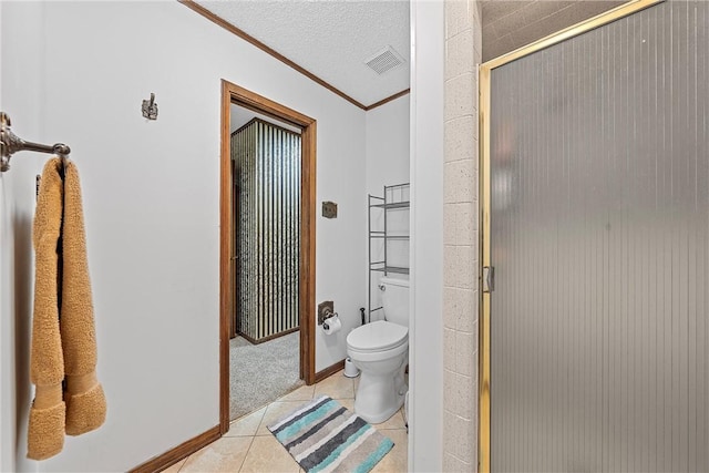 bathroom with tile patterned floors, an enclosed shower, ornamental molding, a textured ceiling, and toilet