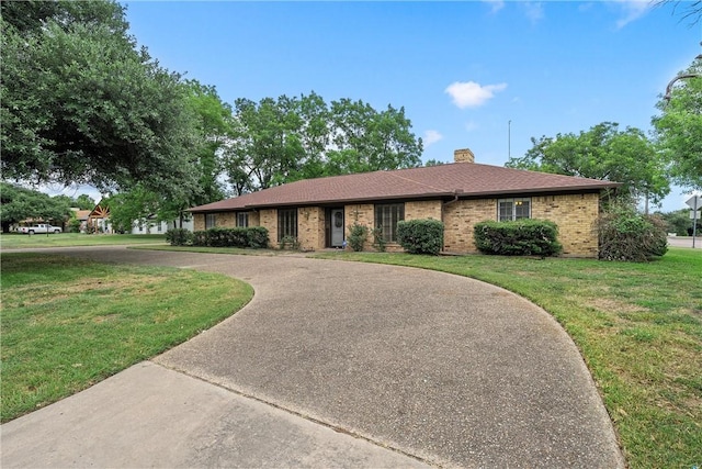 ranch-style house with a front lawn