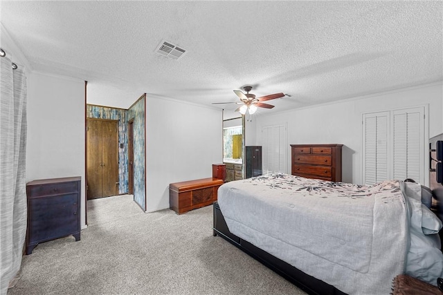 carpeted bedroom featuring a textured ceiling and ceiling fan