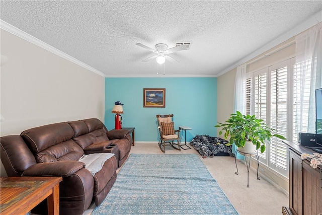 carpeted living room with ceiling fan, ornamental molding, a textured ceiling, and a wealth of natural light