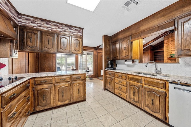 kitchen with black electric stovetop, stainless steel dishwasher, sink, light tile patterned floors, and lofted ceiling