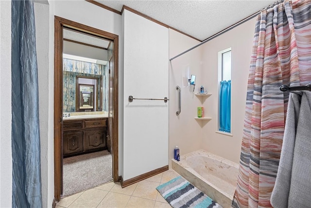 bathroom with tile patterned flooring, a shower with shower curtain, a textured ceiling, vanity, and ornamental molding