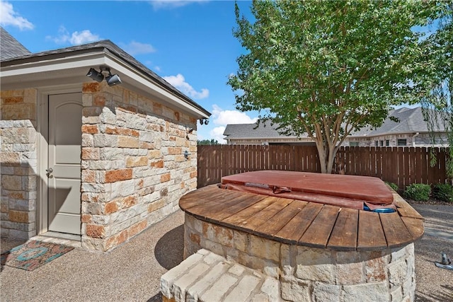 view of patio / terrace featuring a covered hot tub