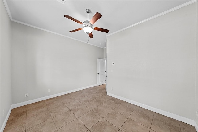 spare room with ceiling fan, ornamental molding, and light tile patterned floors