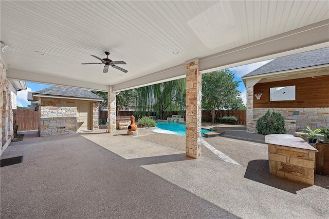 view of patio with a fenced in pool and ceiling fan