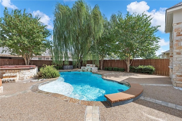 view of pool featuring a hot tub, a patio, and pool water feature