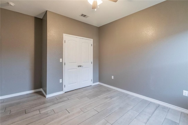 spare room with light hardwood / wood-style floors and ceiling fan