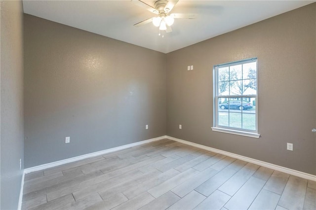 empty room featuring ceiling fan and light wood-type flooring