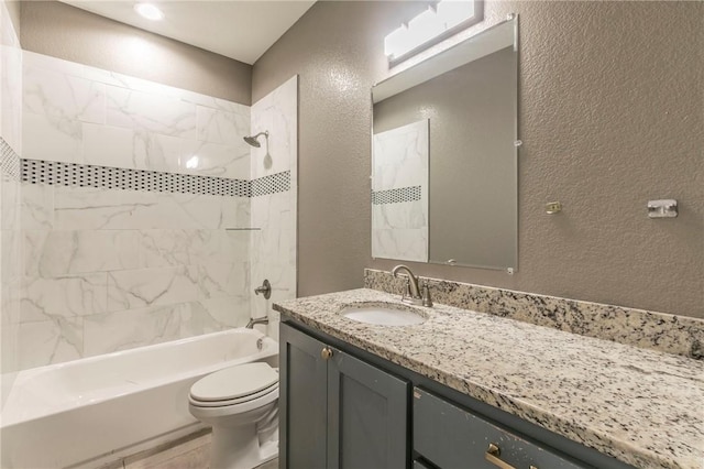 full bathroom featuring vanity, toilet, and tiled shower / bath