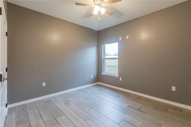 spare room featuring ceiling fan and light wood-type flooring