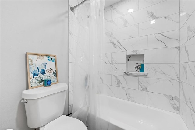 bathroom featuring shower / tub combo and toilet