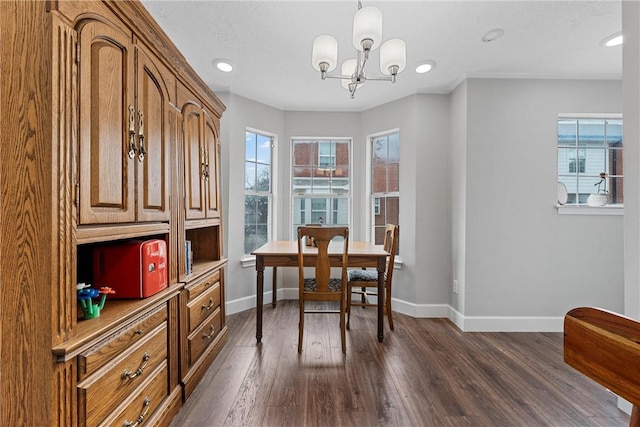 home office with dark wood-type flooring and a notable chandelier