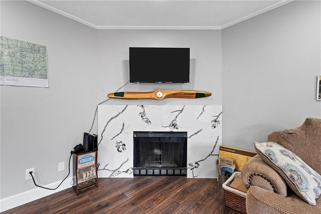 living room with dark hardwood / wood-style flooring, a fireplace, and ornamental molding