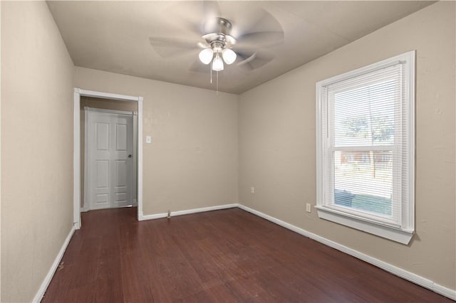 spare room featuring dark hardwood / wood-style floors and ceiling fan