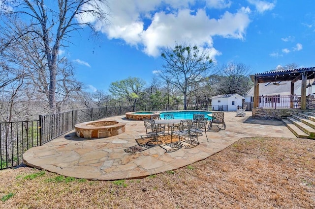 view of pool with an outdoor structure, a fire pit, a patio, and fence