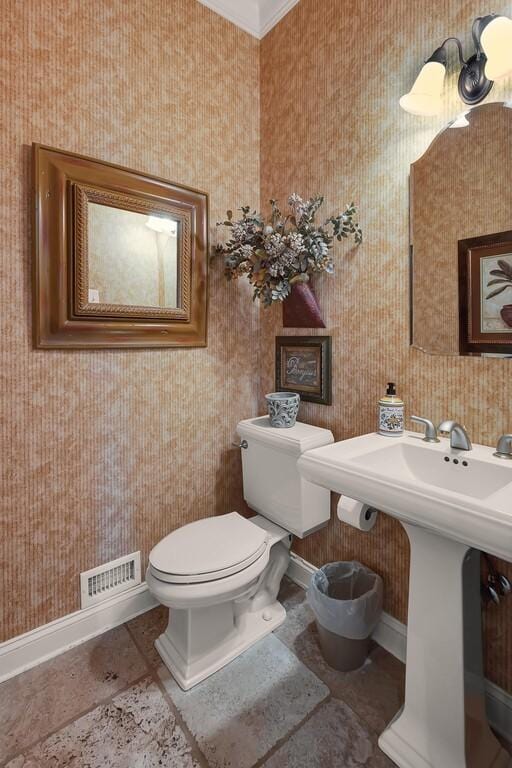 bathroom featuring tile patterned floors, visible vents, baseboards, and toilet