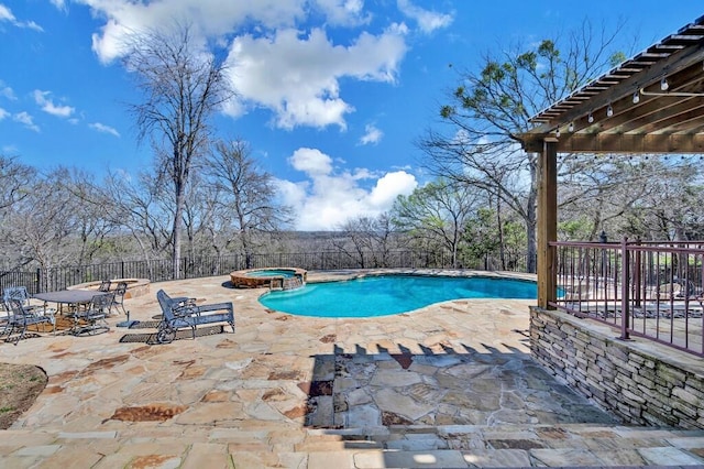 view of swimming pool featuring a patio, a pool with connected hot tub, and fence