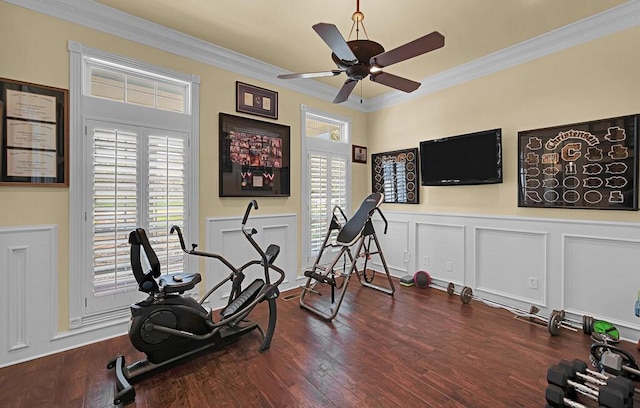 workout area featuring a decorative wall, wood finished floors, and ornamental molding