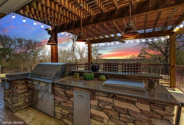 view of patio with area for grilling, fence, a pergola, and grilling area