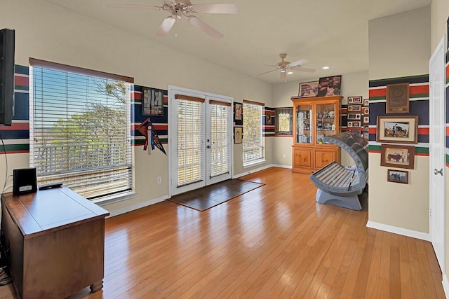 interior space featuring french doors, baseboards, a ceiling fan, and hardwood / wood-style flooring